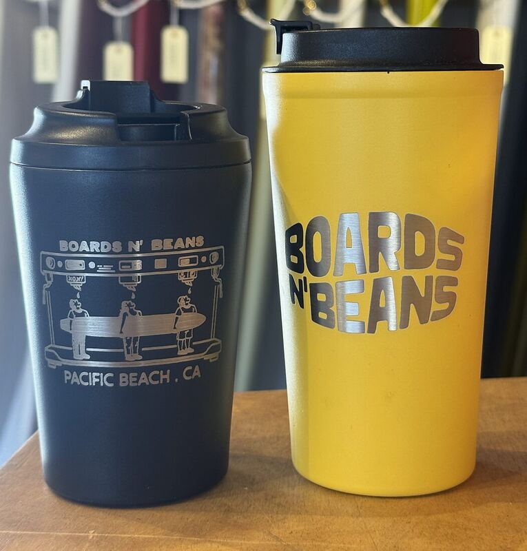 Navy and yellow Boards n' Beans cups with the logo laser-engraved into the finish