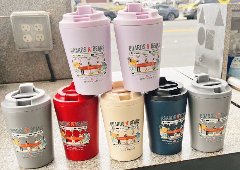 Boards n' Beans cups in pink, gray, red, cream, and navy with a full-color printed logo
