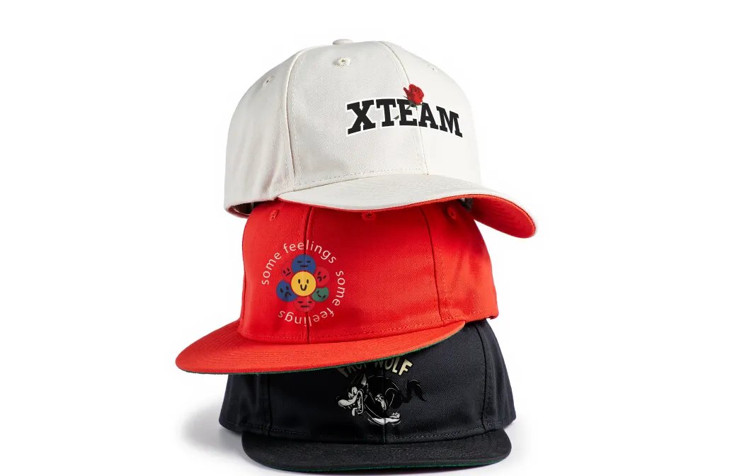 Three caps, cream, red and black, each with a printed logo